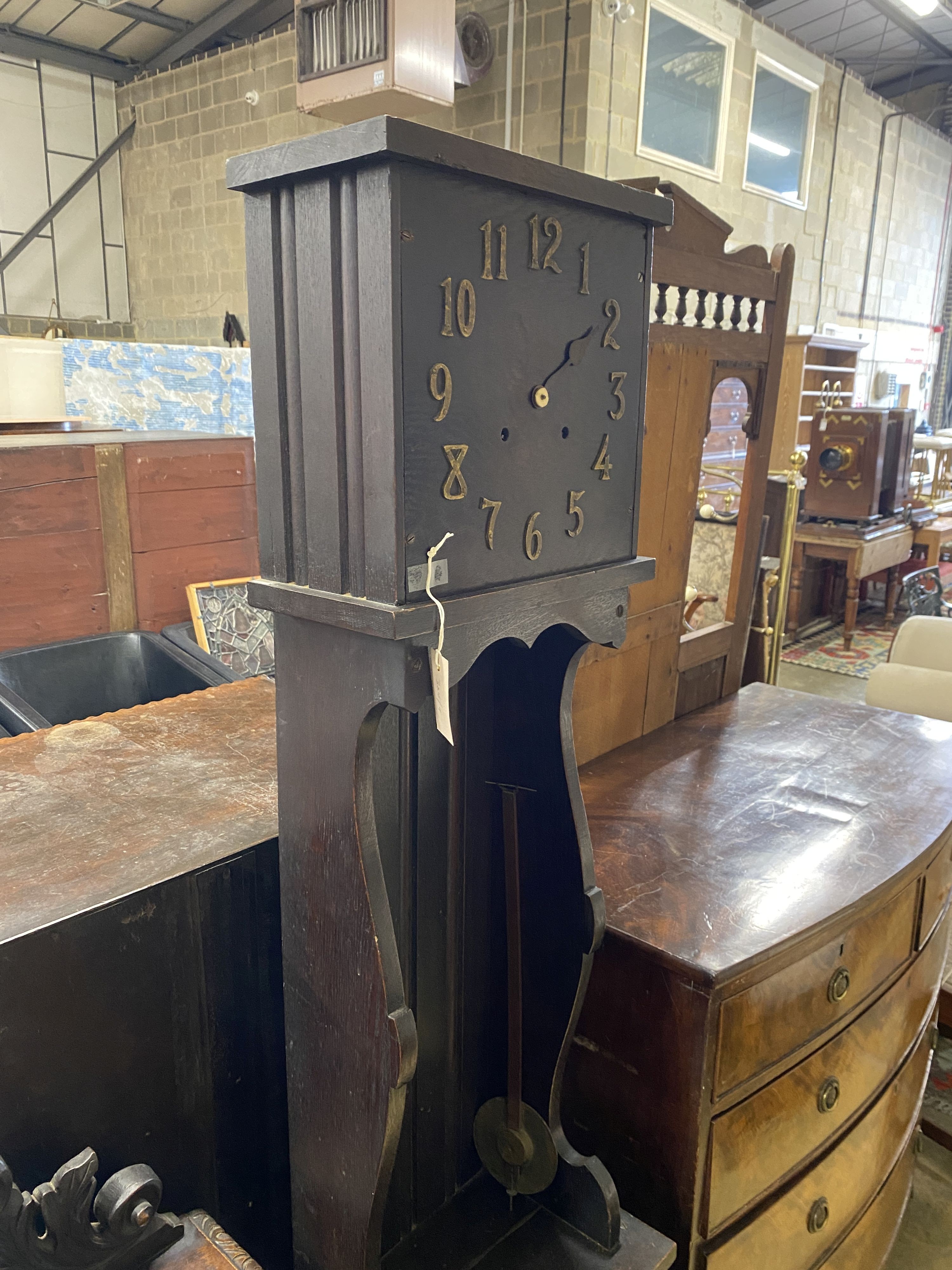 An 'Arts and Crafts' style oak longcase clock, height 184cm